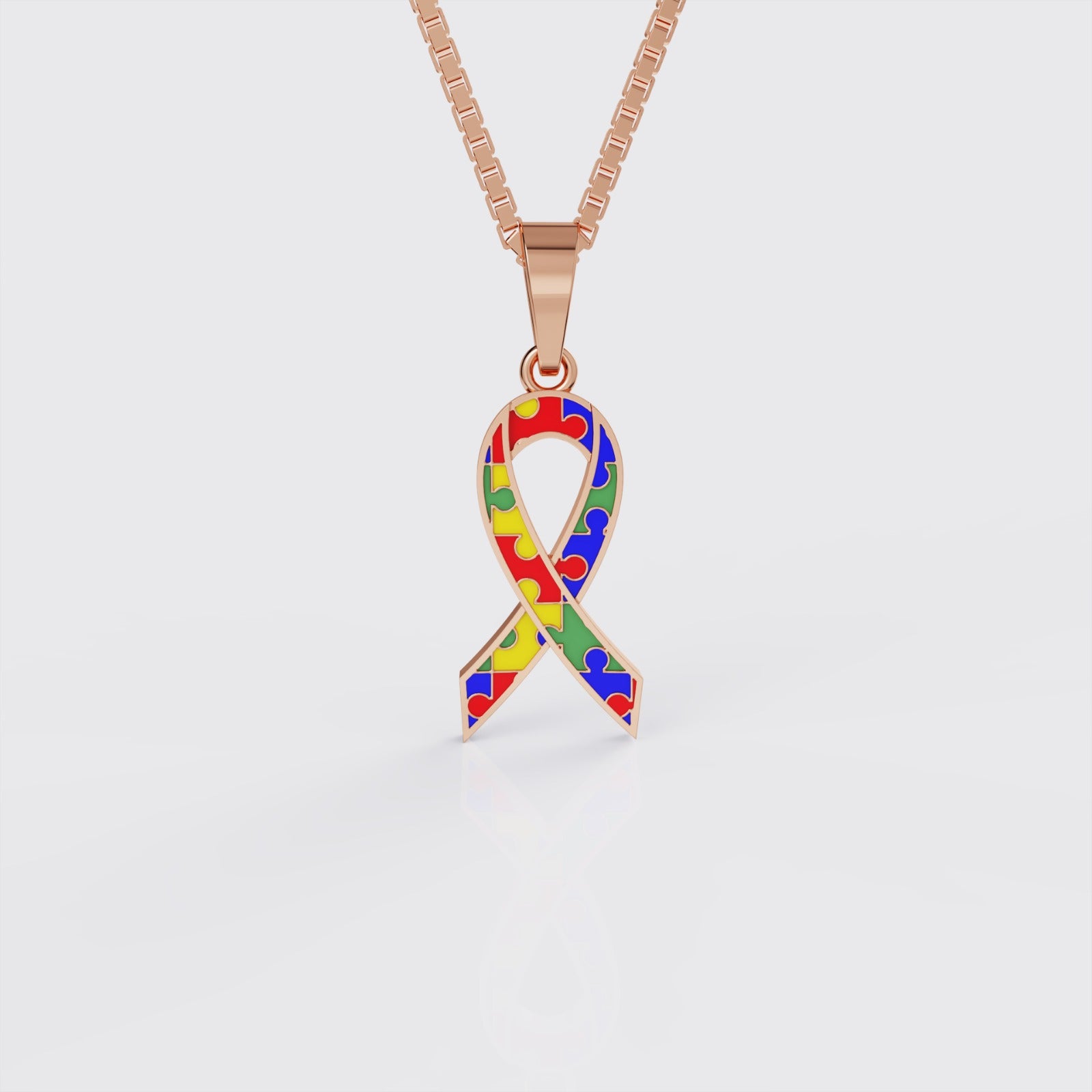 Rose gold autism awareness ribbon pendant necklace, front view.