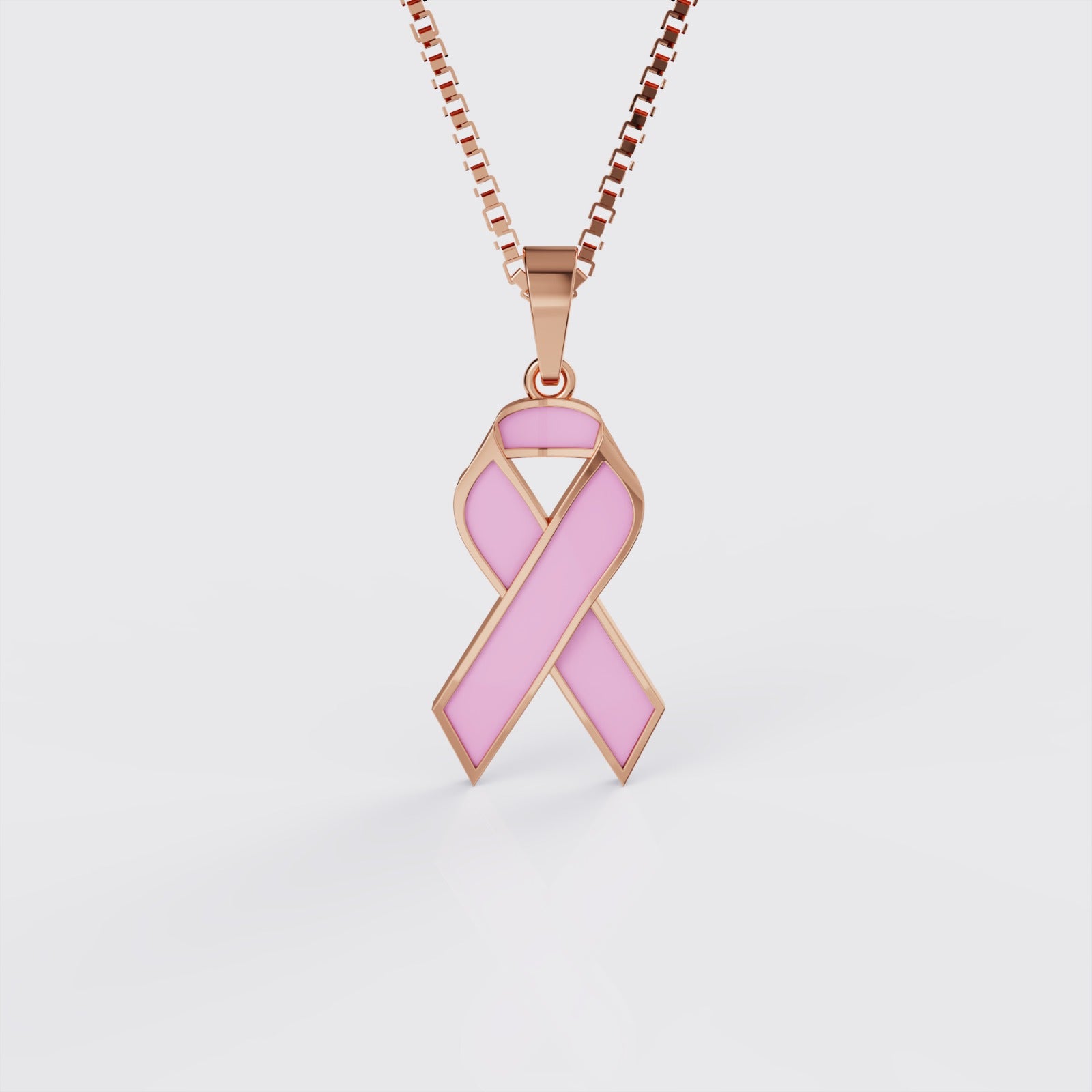 Rose gold breast cancer ribbon pendant necklace with pink enamel, front view.