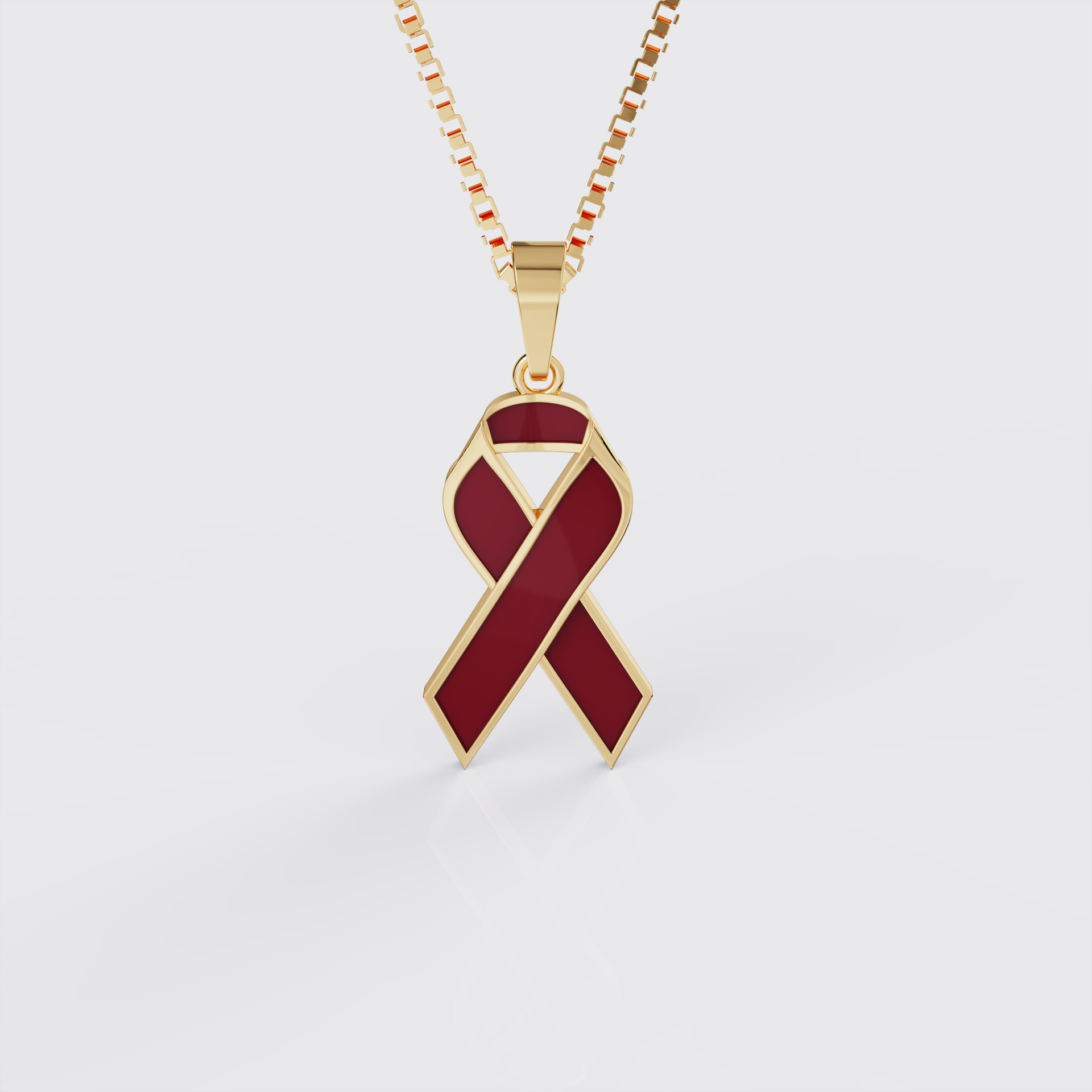 Yellow gold sickle cell awareness ribbon pendant necklace with red enamel, front view.