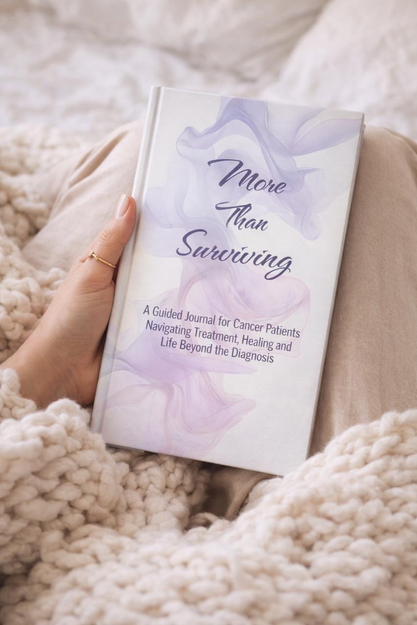 Person holding More Than Surviving guided cancer journal in a cozy setting, designed for emotional healing and reflection.